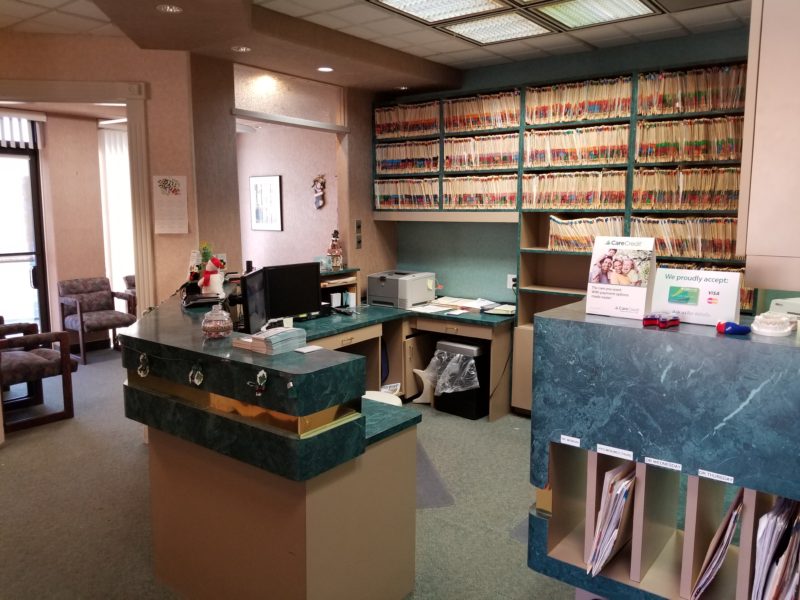 A lobby counter with lots of files on the shelves