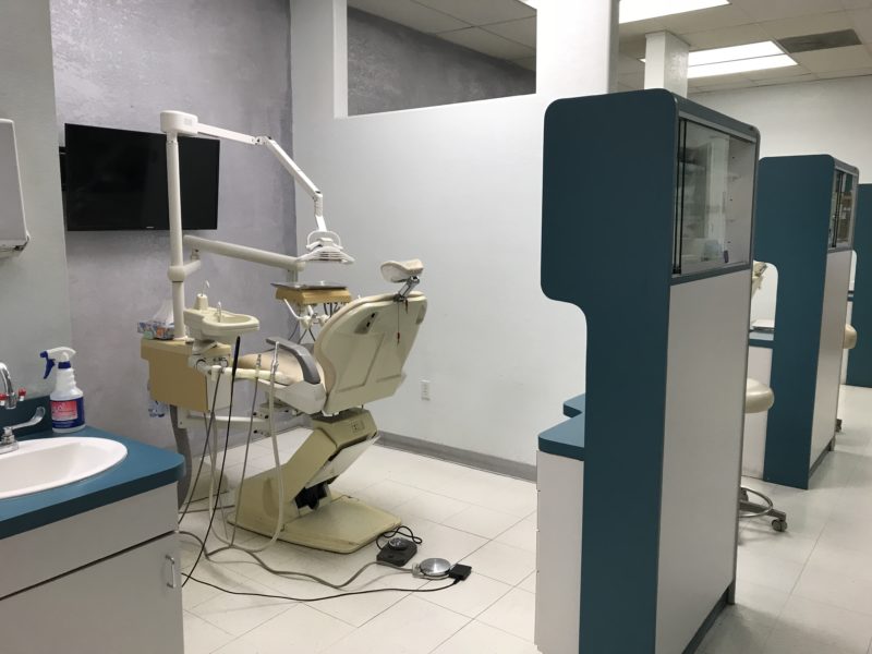 A dental clinic with cream-colored dental chair
